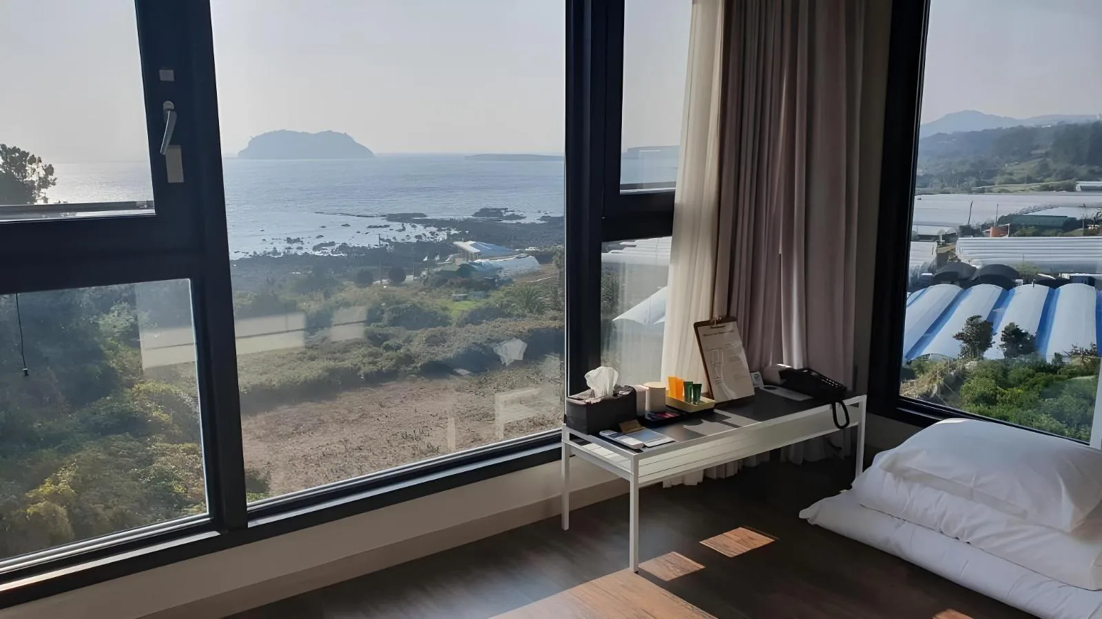 Ondol room at Hotel Seogwipean with floor-style bedding and an ocean view